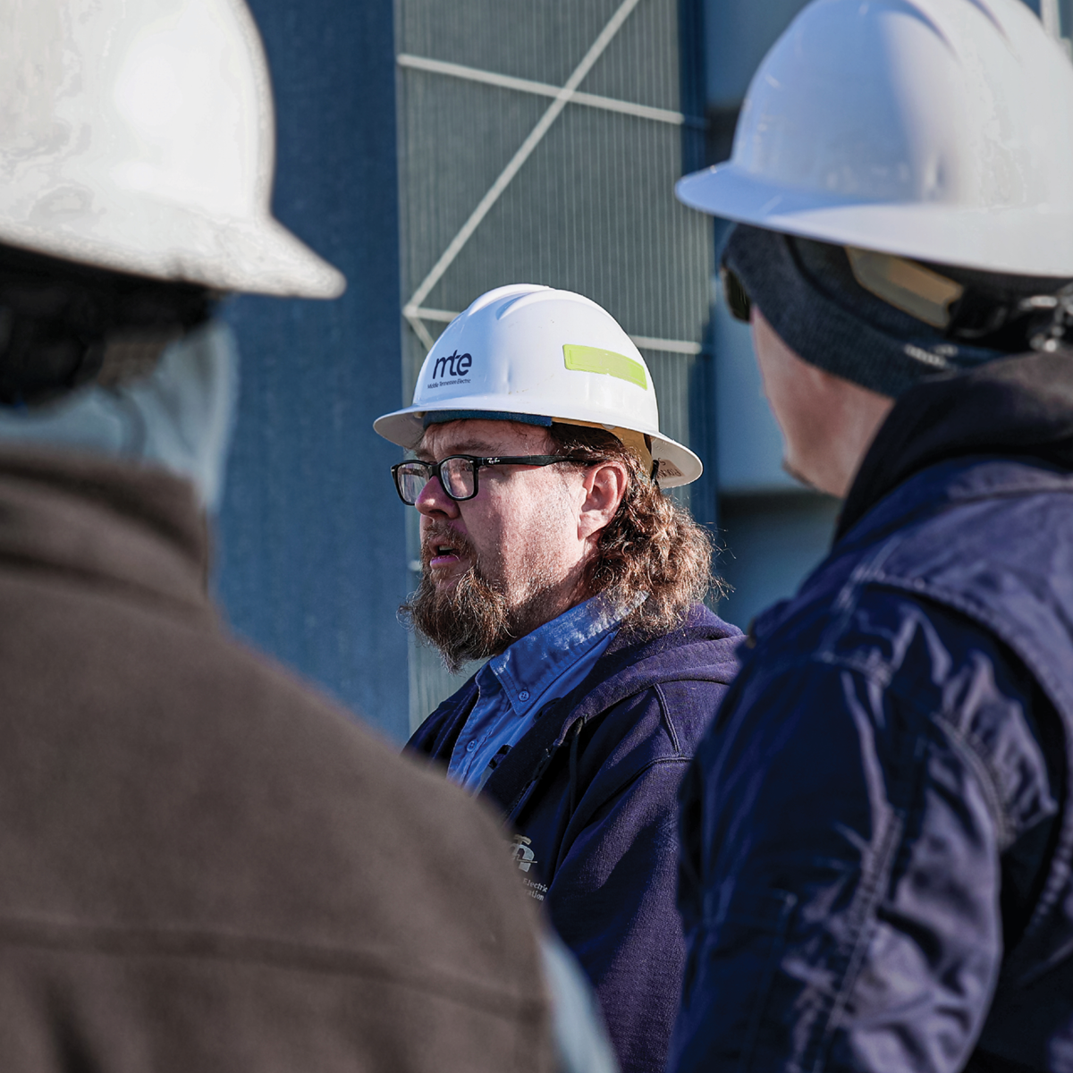 Clive Buttrey speaks with his team