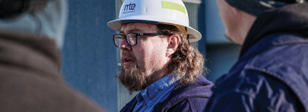 clive buttrey talks with his team