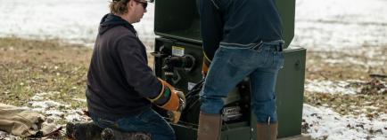 linemen working on underground transformer