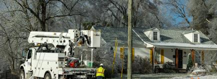 MTE trucks outside a home repairing service lines