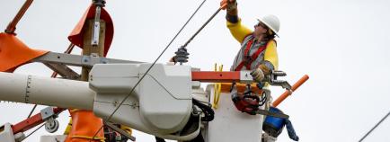 crews work to restore power from their bucket trucks